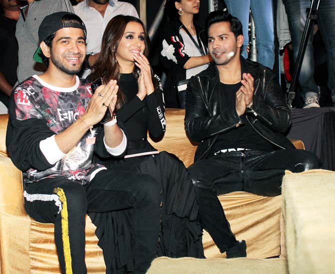 Shraddha looked beautiful in her black long top with a slit at her waist. She teamed it up with matching shorts and knee-length boots. On the other hand, Varun opted for a stylish black leather jacket, t-shirt, and jeans.