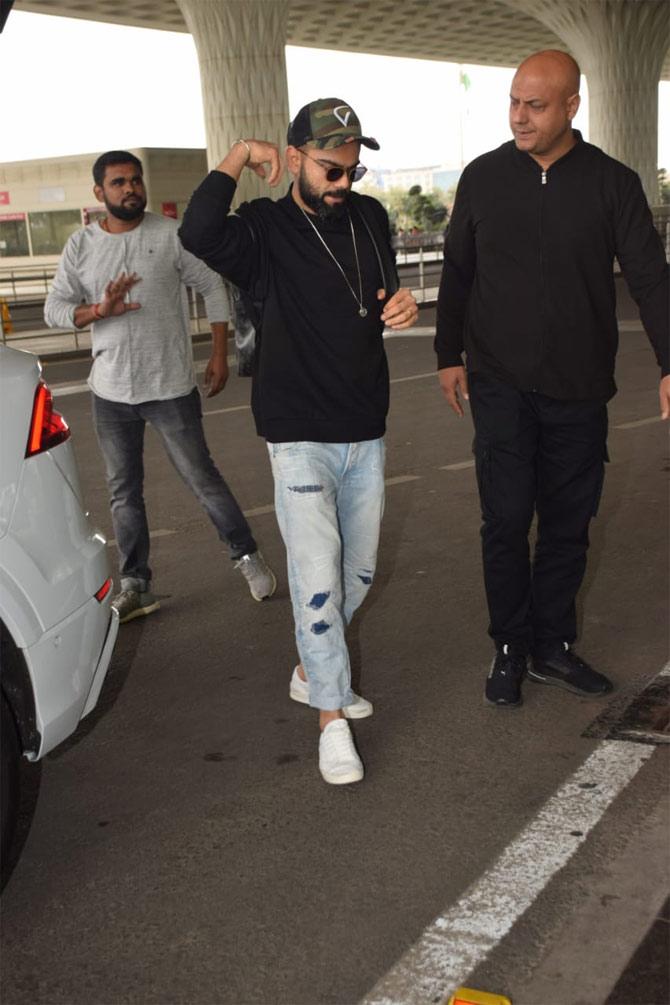 Virat Kohli was seen sporting a black pullover, denims and white shoes.