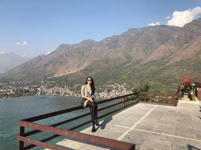 In Srinagar, she poses with poise amidst the Kashmir valley. 