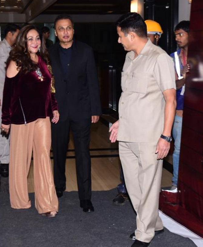 Tina Ambani looked gorgeous in a maroon velvet top and peach pants. She posed alongside her husband Anil Ambani.