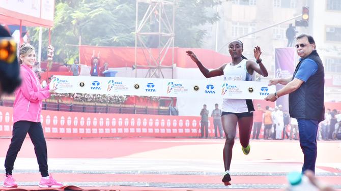 In photo: Ethiopia's Amane Beriso finishes the International Elite Full Marathon Women's race in style
