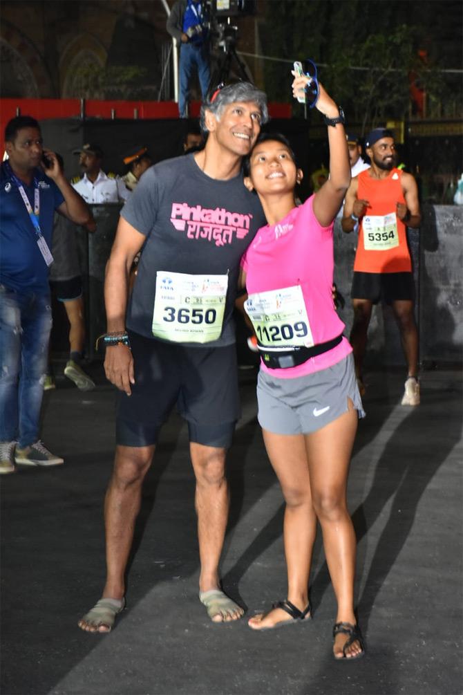 In photo: Milind Soman and Ankita Konwar pose for a selfie during the 17th edition of the Mumbai Marathon