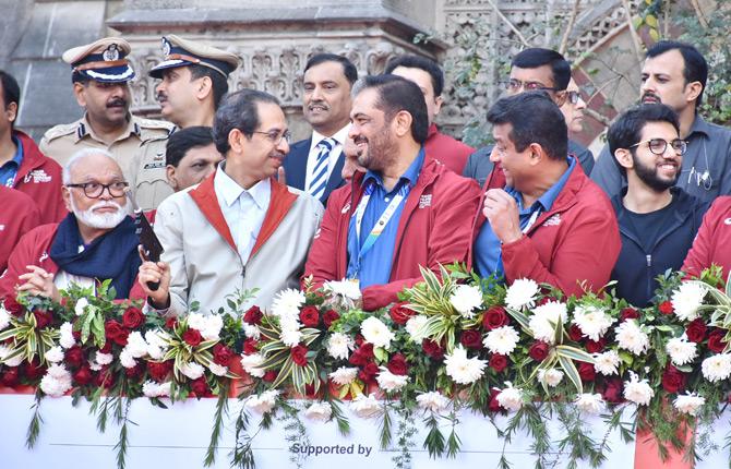 In photo: Maharashtra CM Uddhav Thackeray shares a light moment minutes before flagging off the Dream Raun race at the 17th edition of the Mumbai Marathon