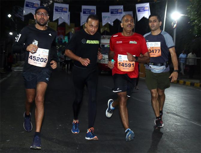 In photo: Anil Ambani caught in a candid moment as he runs the marathon in tandem with seasoned runners.
