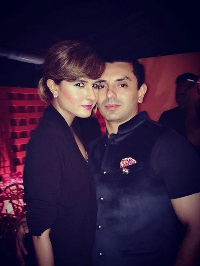 Robert Vadra's cousin, Monicka Vadera posed with her husband Tahseen Poonawalla as she wore a black coat and complimented it with pink lipstick and hair tied in a bun.