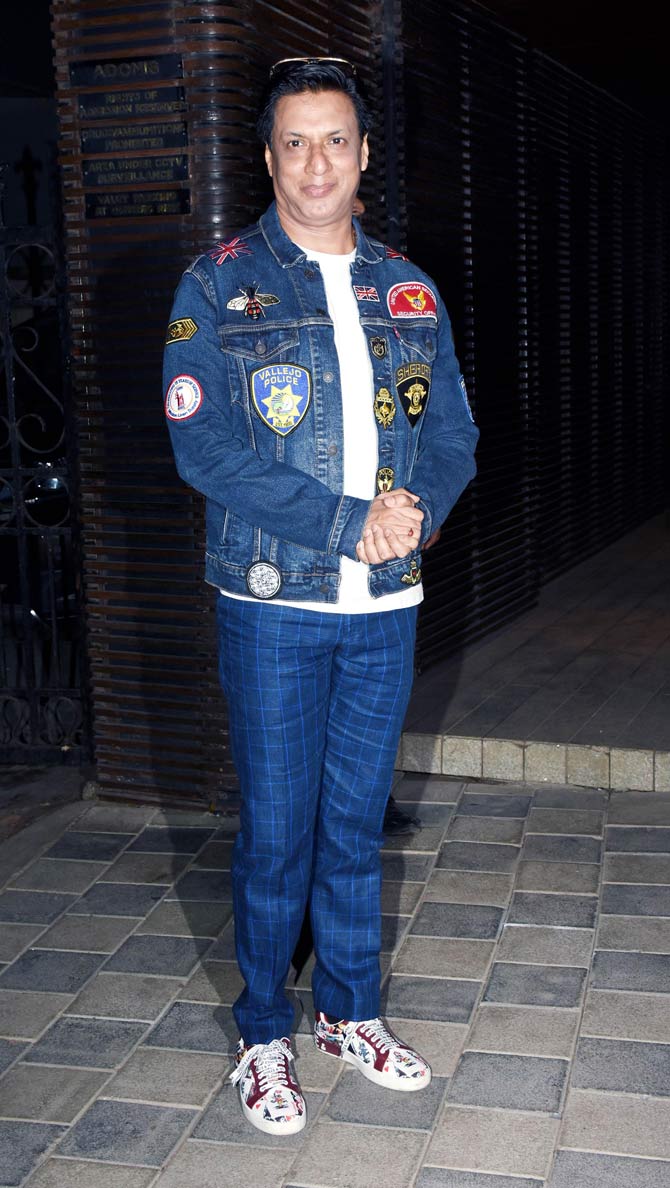 Madhur Bhandarkar opted for checkered trouser pants, paired with a white basic tee and denim jacket to attend Sudhir Mishra's birthday party.