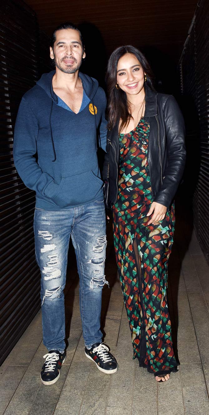 Dino Morea and Neha Sharma attended Sudhir Mishra's birthday bash together. The actor opted for a blue sweatshirt, paired with distressed denim. Neha looked pretty in a thigh-high slit maxi dress during the outing.