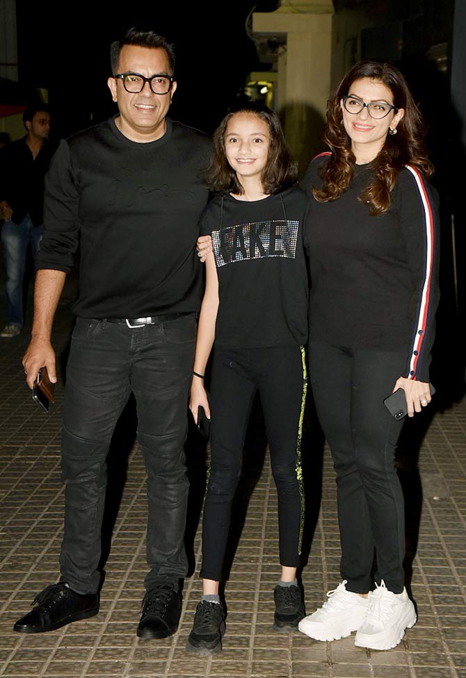Prachee Shah with husband Vishwas Paandya and daughter Khiana pose for the photographers at the special screening of Street Dancer 3D in Juhu.