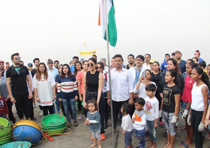 Super 30 actress Mrunal Thakur and others sing the National Anthem post the beach clean-up drive. She shared a photo as well and wrote, 