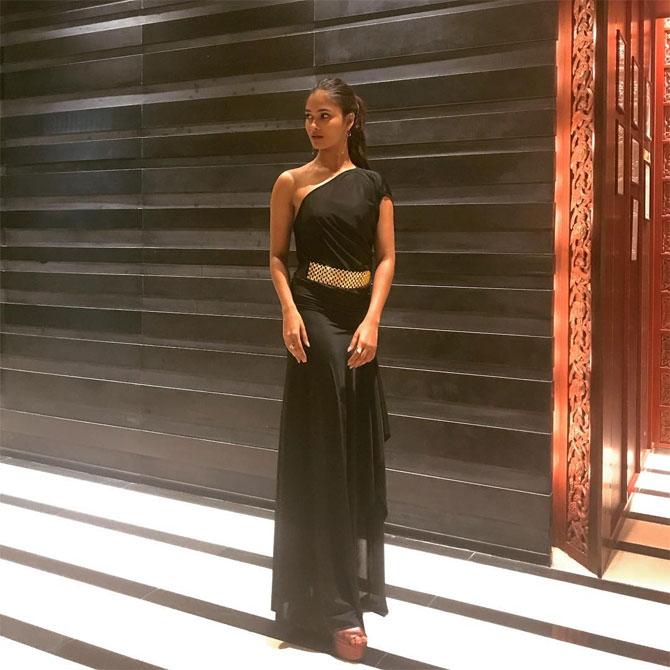 She shines in his black belted gown worn for an event in Thailand with her hair tied into a sophisticated pony.