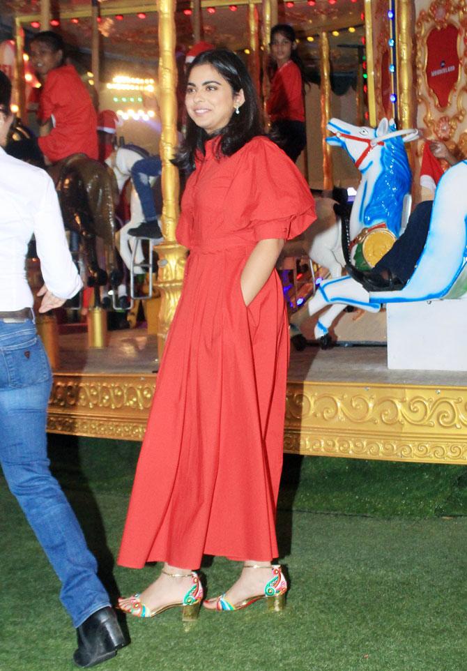Isha Ambani wore a red-buttoned down dress with puffed sleeves. She kept it simple by teaming her outfit with red and blue heels, diamond earrings and subtle make-up with her hair let loose.
