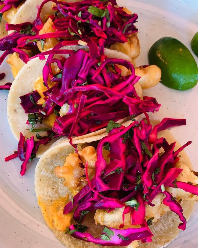 The 31-year-old designer shared this stunning picture where she can be seen enjoying a beautiful dish full of colours which appears to be a Fish Taco. Masaba shared the picture with a tropical fish emoticon.








