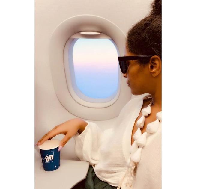 In photo: Masaba Gupta enjoys the scenic view from her window seat as she holds the cup of coffee with love.







