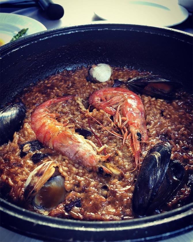 Masaba Gupta swears by Paella, a rice dish that is one of the best-known dishes in Spanish cuisine. The 31-year-old designer can be seen enjoying seafood paella that is full of prawns and oysters. While showing her love for Spanish cuisine, Masaba wrote: It's all downhill from here!




