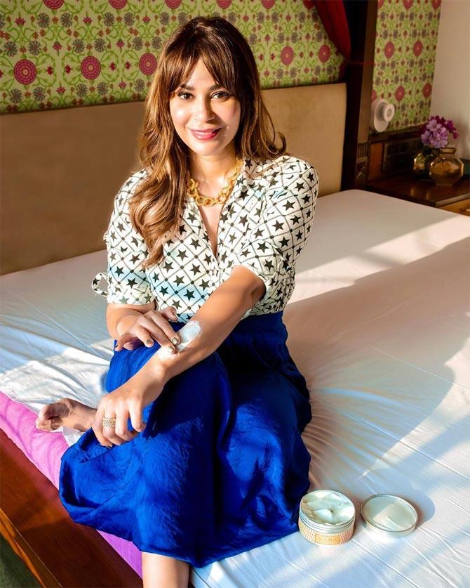 In a semi ethnic avatar, she shines in this white printed shirt and blue skirt with her hair let loose.