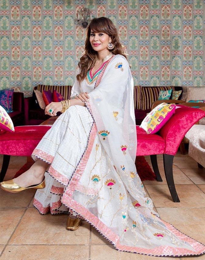 She shows how to keep it simple in white kurti and palazzo with an embroidered dupatta, replete with a pair of statement tassled earrings.