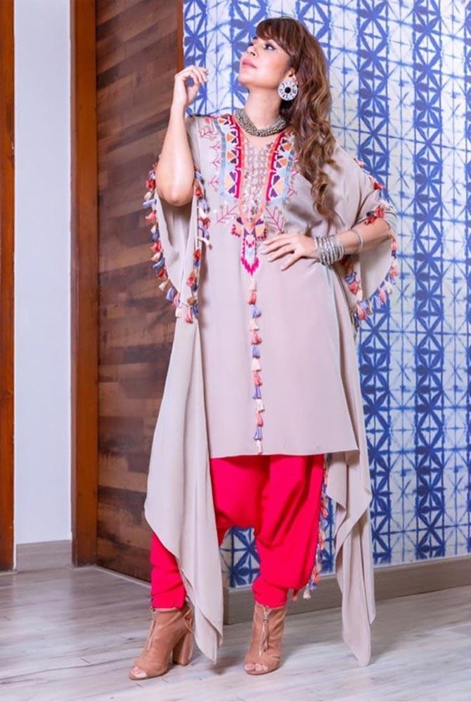 In an Aztec-inspired kaftan styled with a red pajama and a pair of statement earrings, she makes the word 'gorgeous' an understatement. 
