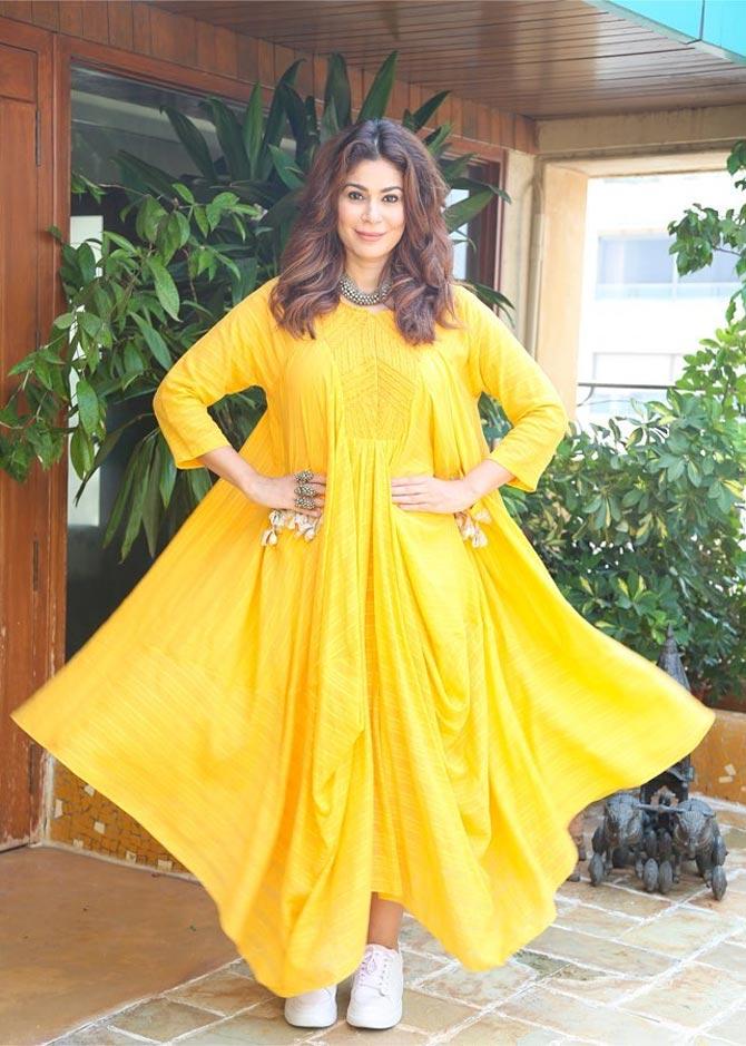 She looks stunning in this semi-ethnic outfit teamed with a pair of white sneakers and a silver choker. 