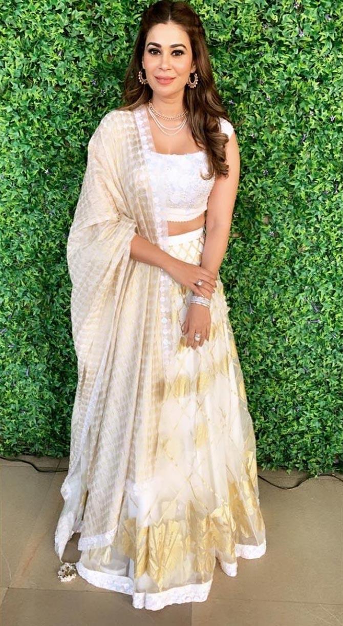 Abbas looks ethereal in this white lehenga with gold details teamed with a pair of statement earrings, layered necklace and bracelet. 
