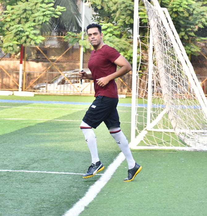 Television presenter and actor Samir Kochhar warms up for the football game at the Juhu ground.
