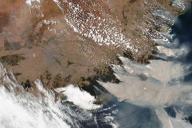While bushfires are common in Australia's dry summers, climate change has pushed up land and sea temperatures and led to more extremely hot days and severe fire seasons. This satellite image provided by NASA on January 4 shows wildfires in Victoria and New South Wales.