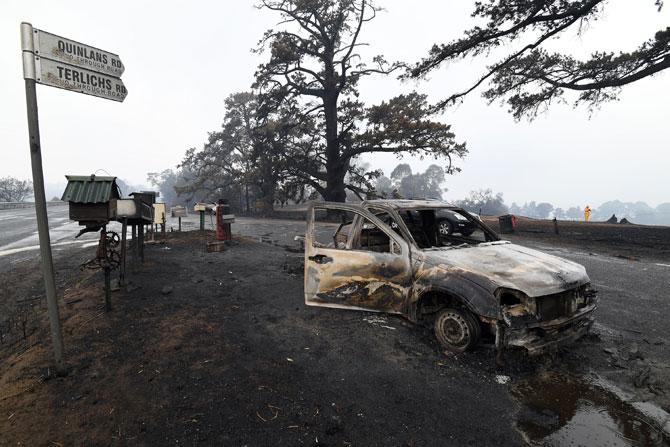 In New South Wales, 18 people lost their lives in 150 bushfires burning, 64 un-contained across the state. More than 3.6 million hectares have been burned with over 1300 homes destroyed.
In picture: A burnt vehicle is seen on Quinlans street after an overnight bushfire in Quaama in Australia's New South Wales state