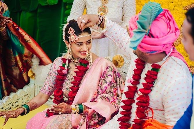 The actress looked ethereal in a baby pink Nauvari sari, while Shardul shone in a cream coloured traditional wedding outfit. Nehha opted for traditional wedding jewellery including the very Maharashtrian green glass bangles and 'nath' (nose ring).