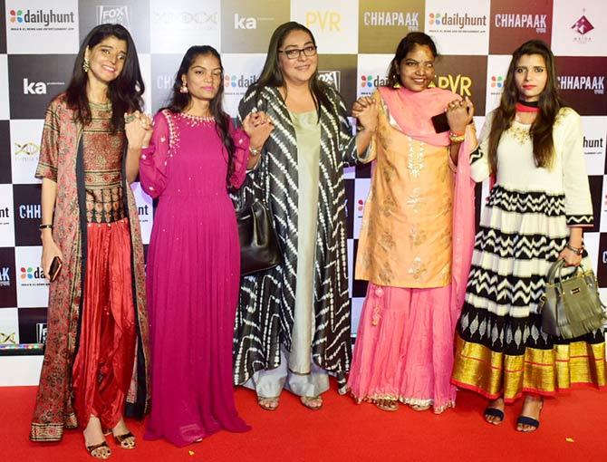 Chhapaak director Meghna Gulzar along with real-life acid attack survivors pose for the photographers at the screening of the film in Juhu.