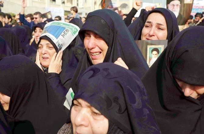 Women weep while mourning in Tehran during a demonstration. Pic/AP