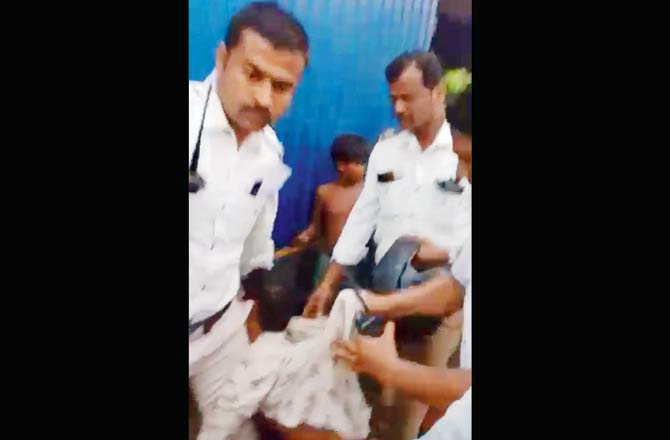 A screen grab of a video shows cops arresting Shabir Abdul Rahman Shaikh