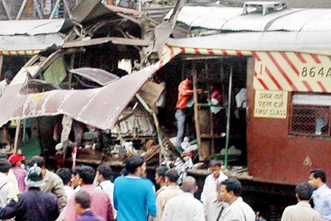 People look to help passengers in the coach, 864-A, right after the blasts. File pic