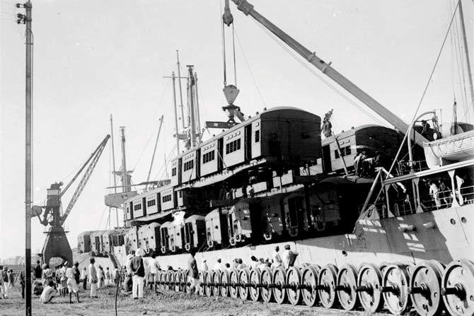 An electric local arriving in Mumbai at the docks in the 1930s. The metal boxes had wood-panelled interiors