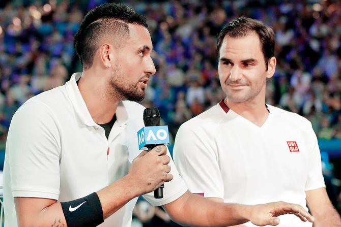 Australia’s Nick Kyrgios (left) chats with Switzerland’s Roger Federer in Melbourne yesterday