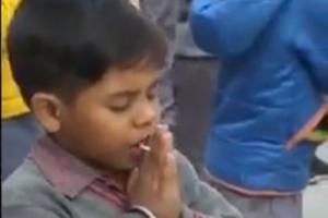 Little boy eating candy during assembly will remind you of childhood