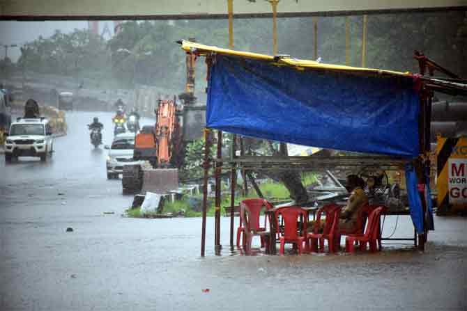 The private weather agency also said that rains is likely to continue in Mumbai for the next three to four days after July 5 and the showers will provide some respite from the sultry weather.
In picture: A makeshift police checkpoint gets flooded near the Eastern Express Highway in Thane.
