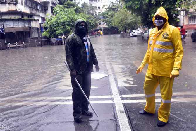 The IMD has issued an orange alert (an indication for very heavy rain) for Mumbai for Saturday, and yellow alert (an indication for heavy rain) on Sunday.
In picture: A person interacts with a police officer near a waterlogged road in Sion.