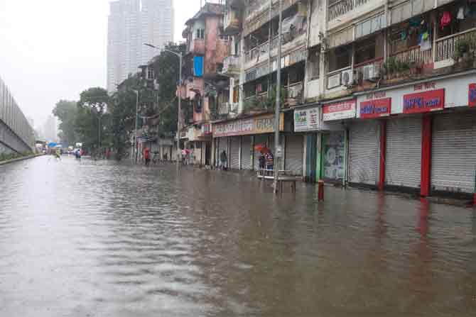 The city witnessed rain showers through the intervening night of Thursday, which turned into heavy rainfall on Friday morning and the downpour continued throughout the day.
In picture: A waterlogged street at Parel.