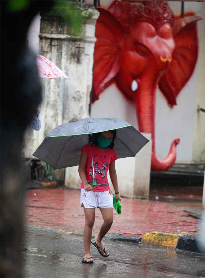 Mumbai Police took to Twitter on Thursday to share a warning for heavy rains in which they advised people to stay indoors and take necessary precautions.
In picture: A girl takes a stroll during the rain in Sion.