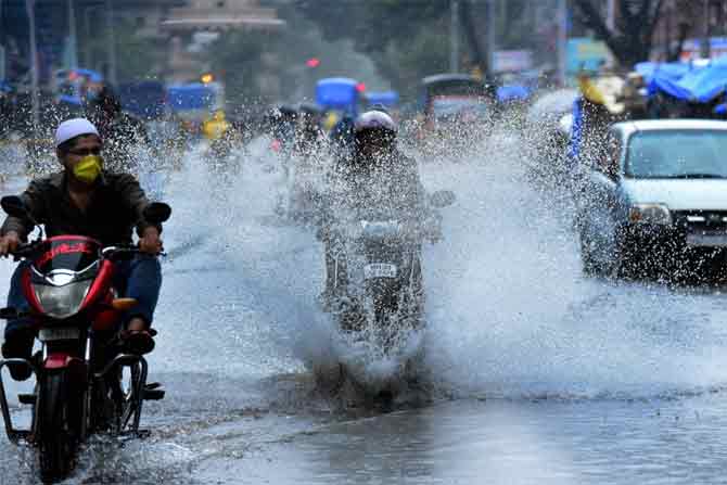 In picture: Motorists ride their vehicles on a waterlogged road near Null Bazaar in South Mumbai