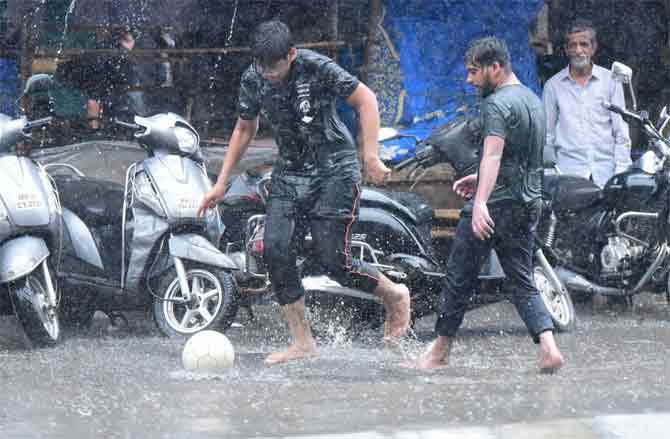 With severe water-logging being reported at many places in Mumbai, the BMC took to Twitter on Friday to issue a list of dos and don’ts to ensure the safety of the people.
In picture: Men play football during the rains in Kumbharwada.