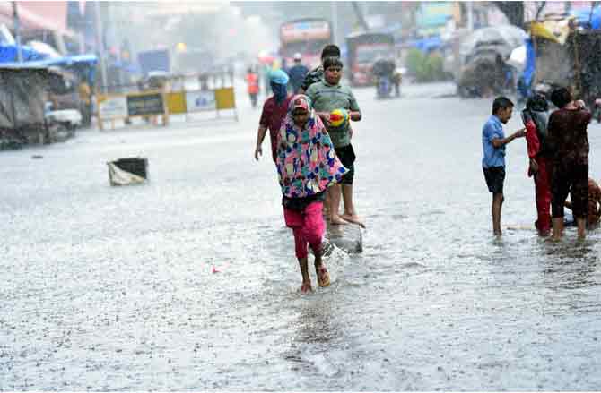According to the Indian Meteorological Department, the Colaba observatory received 161.4mm of rain, whereas the Santacruz observatory received 102.7mm of rain on Friday.
In picture: A girl walks through a waterlogged road in Parel.