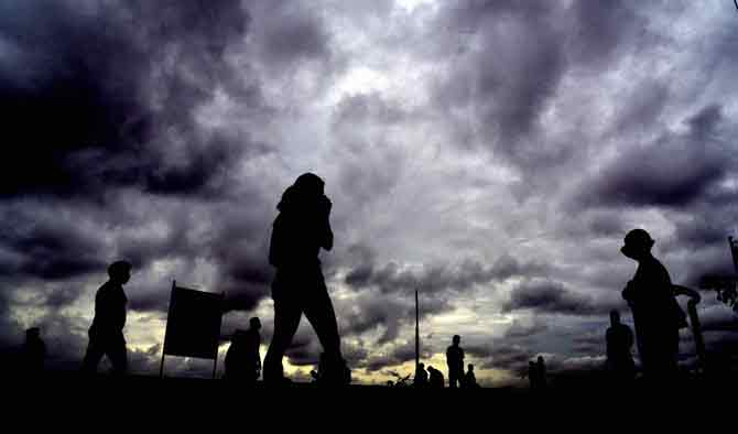 People taking a stroll at Marine Drive enjoy the cloudy evening.