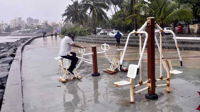 A man works out in an open-air gym in Bandra