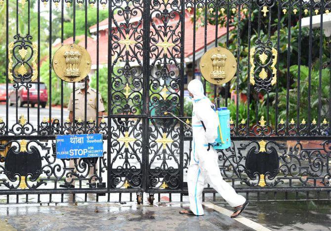In photo: A BMC worker sanitizes Raj Bhavan after some staffers tested positive.