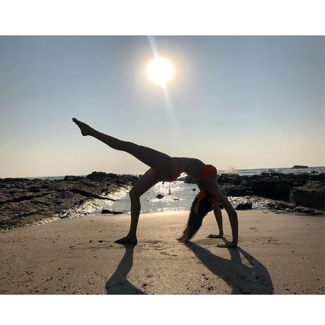 She shared this throwback picture of herself performing yoga on a beach and wrote, 