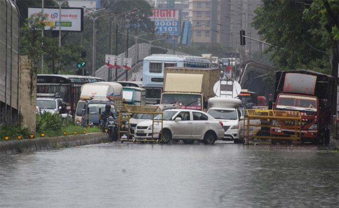 As heavy rains continued to lash several parts of the city and its surrounding areas, Mumbaikars were seen rushing to catch BEST buses and walking through knee-deep waters to reach their offices.