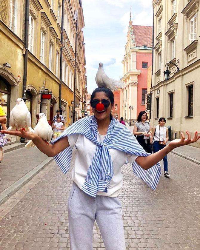 In photo: Ananya Birla shows fans her funny side as she poses with a huge red clown nose with birds resting on her arms and head in Warsaw, Poland.