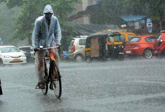In photo: A man rides his bicycle during intense spell of rainfall near Veer Savarkar Chowk in SV Road in Malad East. 