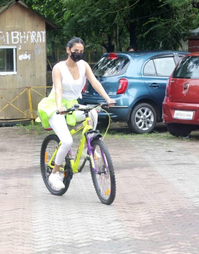 With the lockdown restrictions easing in Mumbai, B-Town folks can be seen shopping, working out or strolling the streets. Actress Sonal Chouhan gave the photographers her trademark cute smile as she was snapped cycling at Versova. (All pictures: Yogen Shah).