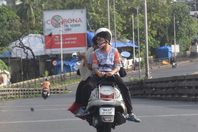 In photo: A child enjoys a bike ride with his family as they pass through Byculla.
The BMC has claimed that the doubling rate of cases has decreased from 12 days in May to 54 days in July.